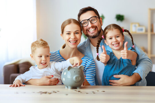 financial planning happy family mother father and children with piggy Bank at home