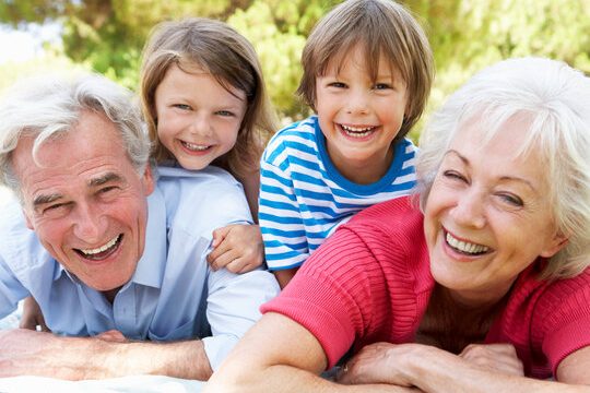 Grandparents And Grandchildren In Park Together