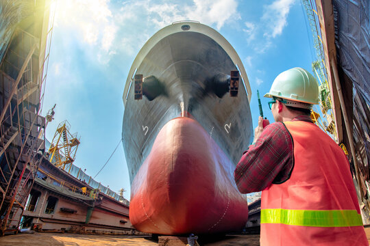 inspector, surveyor, port control or engineering and supervisor in review of the condition of the commercial ship bulk head after repainting recondition in dry dock yard, report, online
